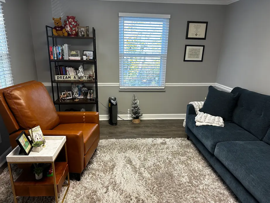 A Towler Counseling office with a leather recliner, navy sofa and window